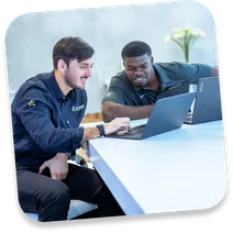 Two Astra strategists working on a laptop
